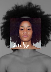 a black woman with an afro on her face